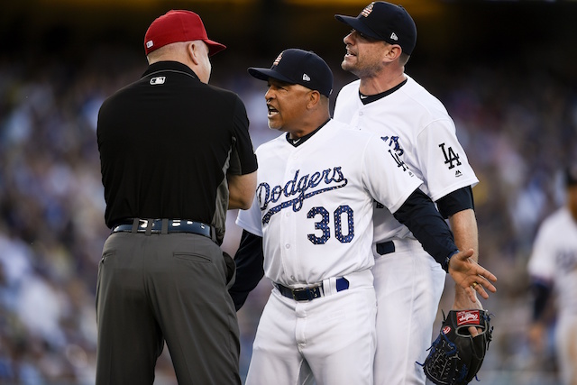 Arizona Diamondbacks second baseman Orlando Hudson, left, regains his  balance after San Diego Padres' Dave Roberts was unable to keep Hudson from  completing a double play during a baseball game Tuesday, May