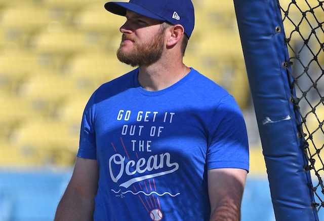 Los Angeles Dodgers first baseman Max Muncy wears a 'Go get it out of the ocean' t-shirt during batting practice at Dodger Stadium