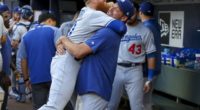 Los Angeles Dodgers teammates Rich Hill and Justin Turner embrace before a game at SunTrust Park