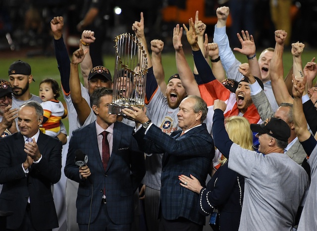 MLB commissioner Rob Manfred presents the 2017 World Series trophy to owner Jim Crane, manager AJ Hinch and the Houston Astros at Dodger Stadium