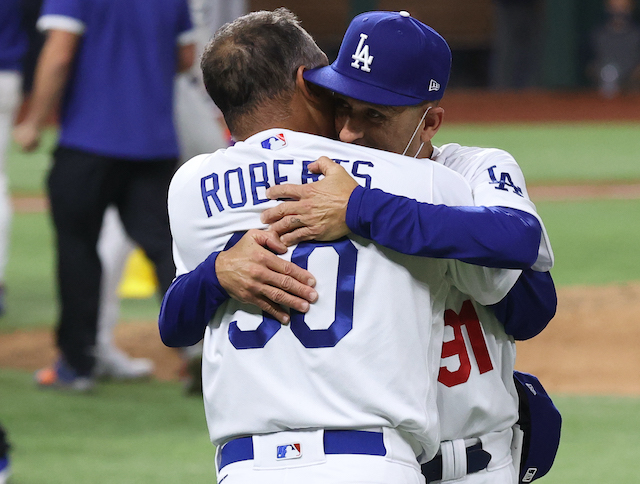 Los Angeles Dodgers' Max Muncy, left, greets Dino Ebel in the