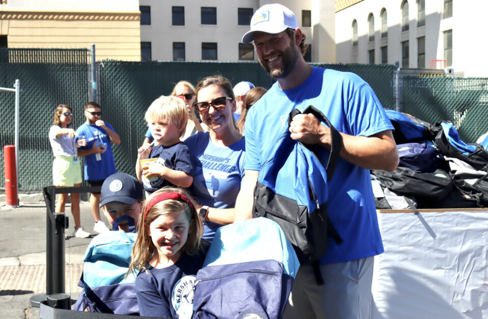 Justin Turner of the Dodgers distributes back-to-school backpacks